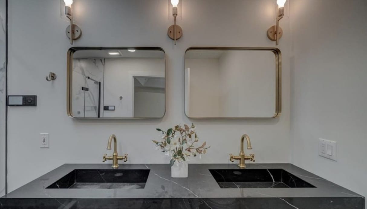 Black marble vanity with brass fixtures
