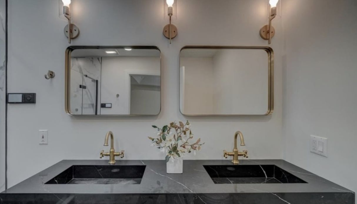 Black marble vanity with brass fixtures